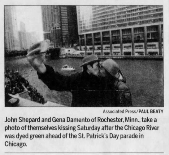 Couple kissing after Chicago River was dyed green